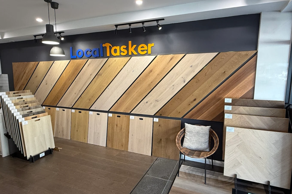 Exterior of Local Tasker store with signage showing wholesale SPC carpets, tiles, and timber.